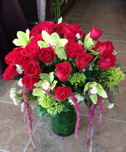 Red rose and dahlia arrangement in a low vase, front view