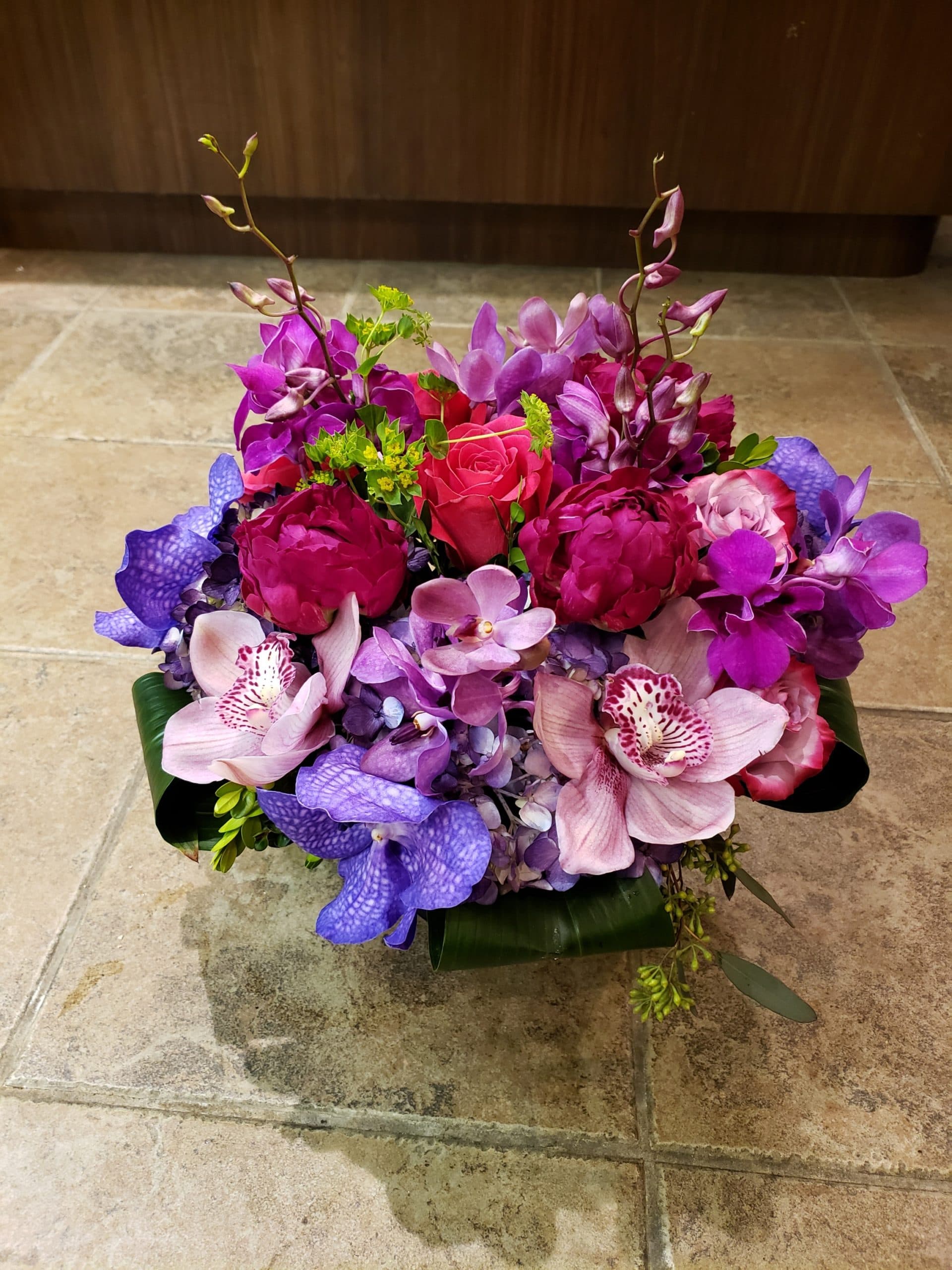 Magenta Majesty arrangement with magenta peonies and orchids