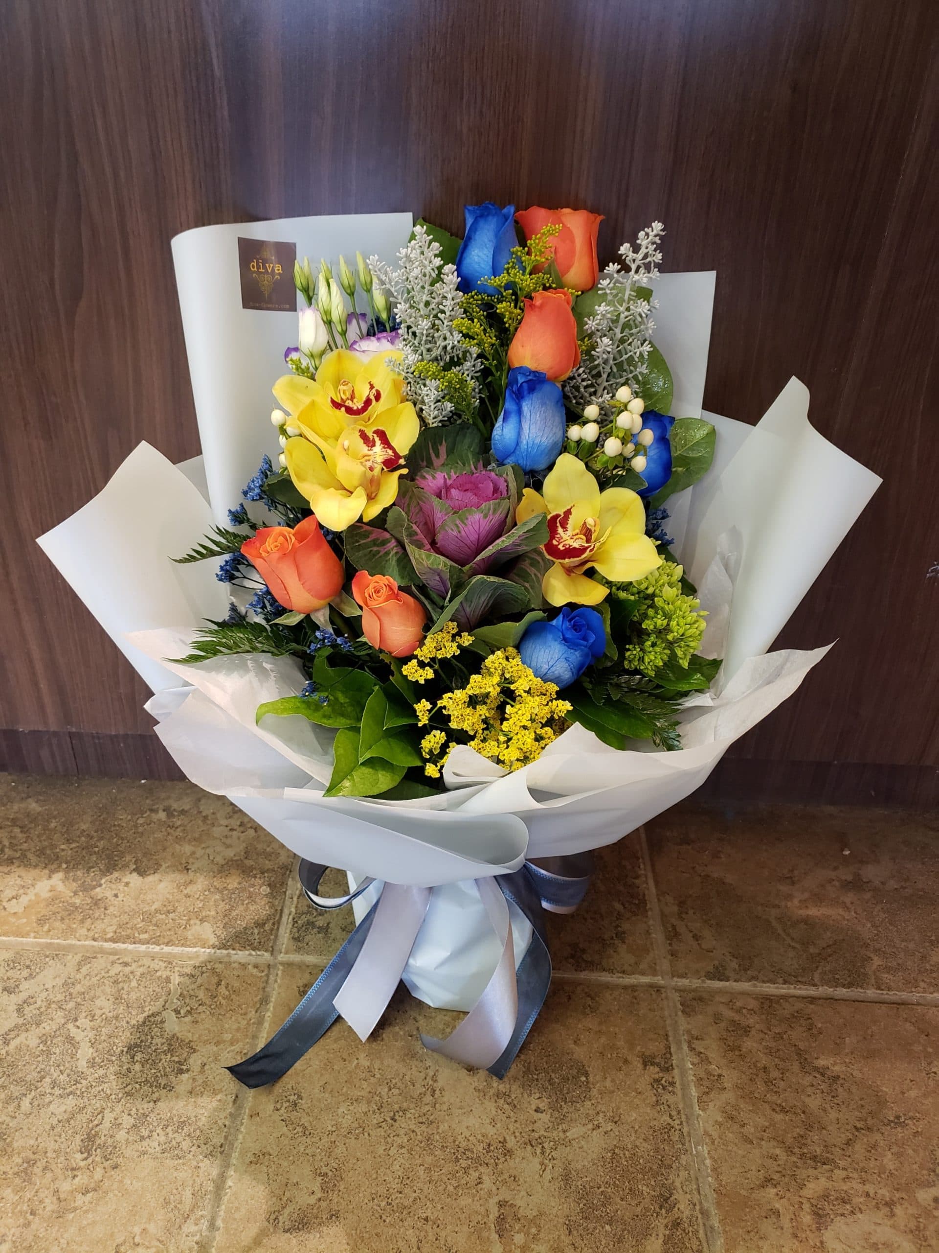 Hand-tied bouquet of sunflowers, orange gerbera, and yellow roses