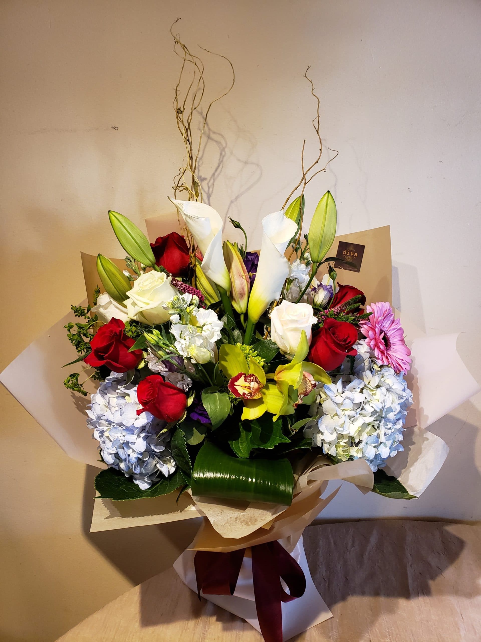 Sunset Estate arrangement with coral, amber, and cream roses