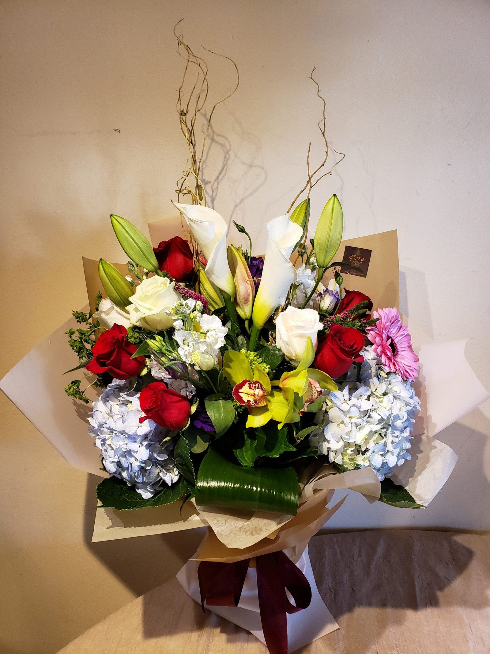 Sunset Estate arrangement with coral, amber, and cream roses