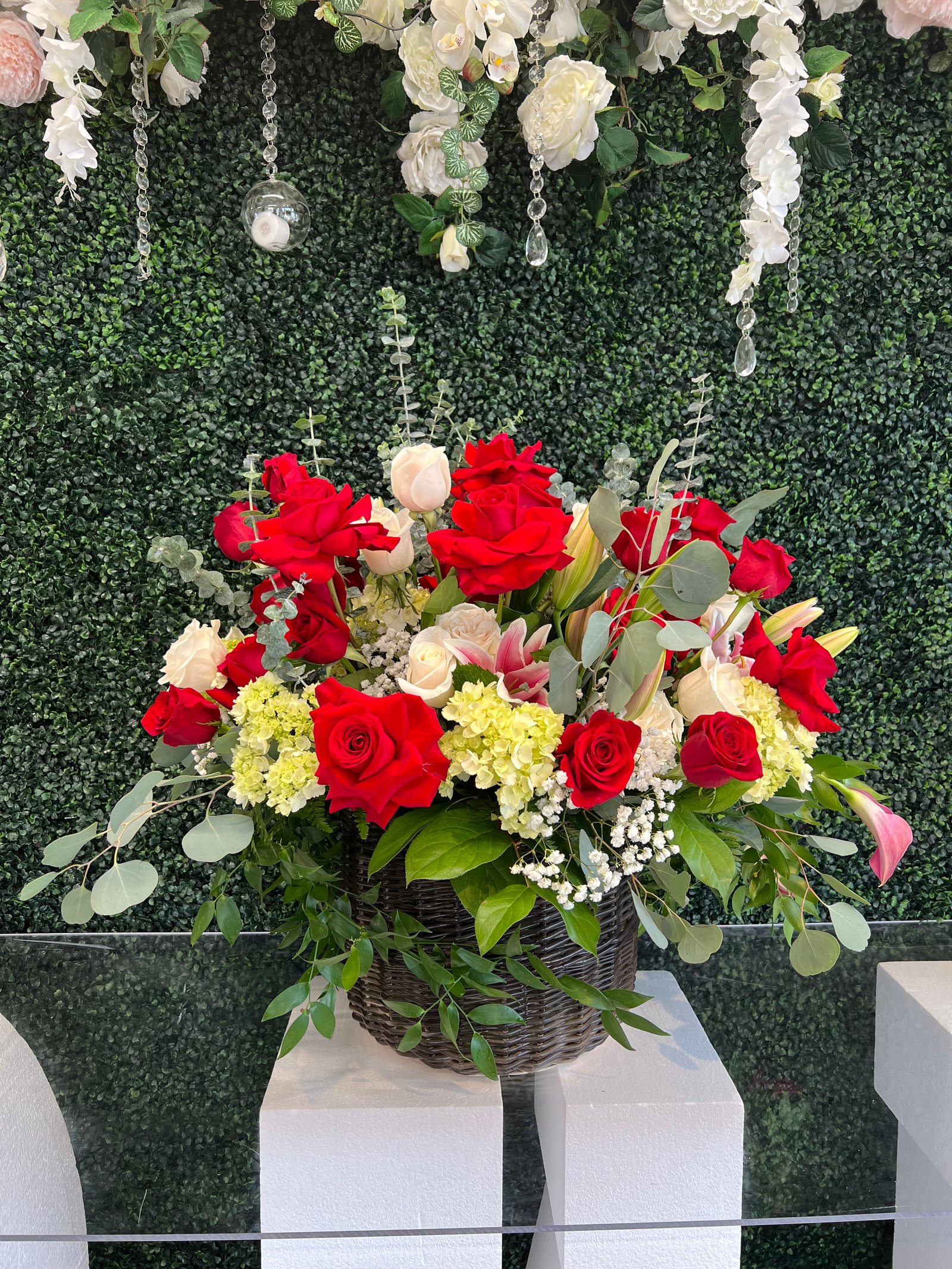 Thorn and Grace sympathy arrangement with white roses and olive branches
